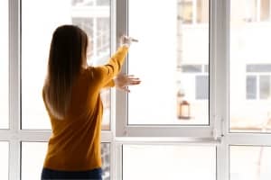 a woman closing a window
