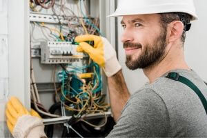 A technician working on an electrical panel