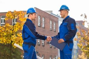 Two HVAC technicians shaking hands