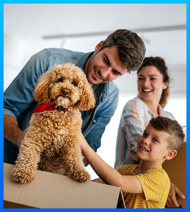 Happy family moving into a new home with their dog